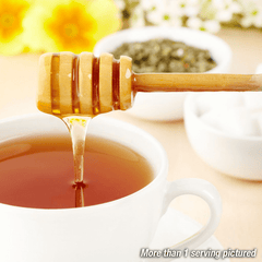 Honey being poured into a cup of tea.