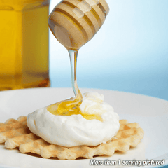 Honey being poured on a dessert.