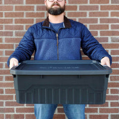 Man holding one of the Large stackable storage totes