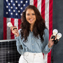 Person holding 4Patriots 3-Strand LED light string with flag hanging behind her.