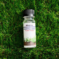 Bottle of 4Patriots bountiful green plant food laying in the grass