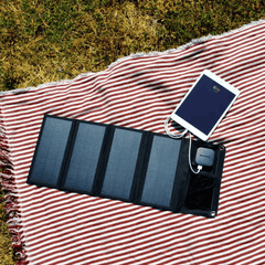 PocketSun solar panel charging in the sun while charging a tablet device
