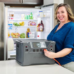 Woman powering her refrigerator by using the Patriot Power Generator 2000X.