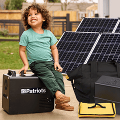 Boy sitting on Solar Generator with solar panels in background.