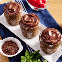 Three jars of chocolate pudding on a white tray
