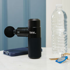 Size reference. Rapid Fire Micro Massager standing up next to a water bottle