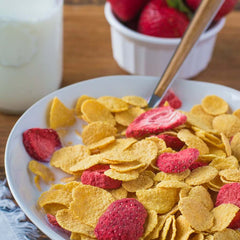 Strawberries in a bowl with cereal.