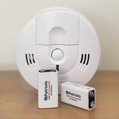 USB Rechargeable 9V Battery Kit next to a smoke detector.